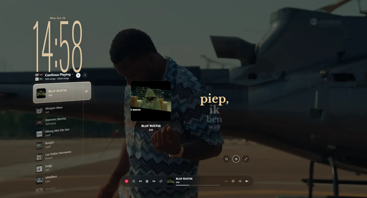 KM's Blijf Rustig: the music video plays as the wallpaper, the lyrics beside it, and light in the song's colours around the screen.